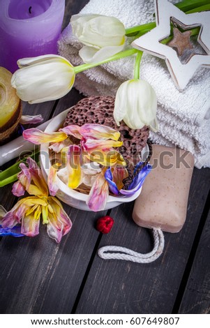 Spa backgrounds with dry withered tulips on wooden table