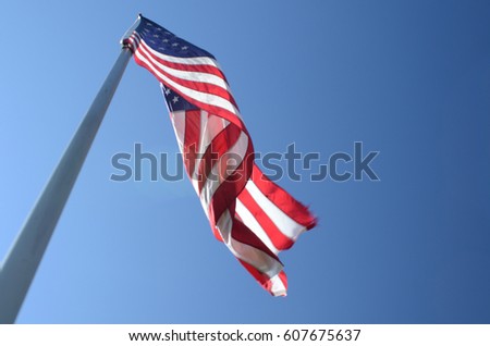 American flags on flag poles Royalty-Free Stock Photo #607675637