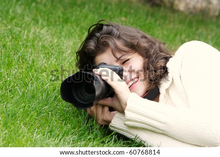 young girl taking picture on natural background