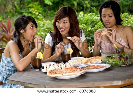 A bunch of friends having a picnic together in the garden