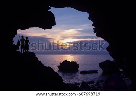 Couple camping on the island with kayaking and purple sky sunset background