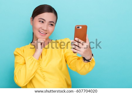Woman making selfie photo on smartphone