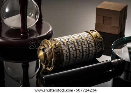 Escape the room or escape game, is a physical game where players are locked in a room and a required to examine clues and solve a puzzles. The word Xcape?� is the password for this cryptex riddle Royalty-Free Stock Photo #607724234