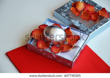 Easter composition. Colored silver eggs in a decorative box, rose petals. Staining of Easter eggs.