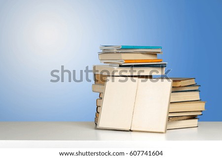 A pile of books on wooden table