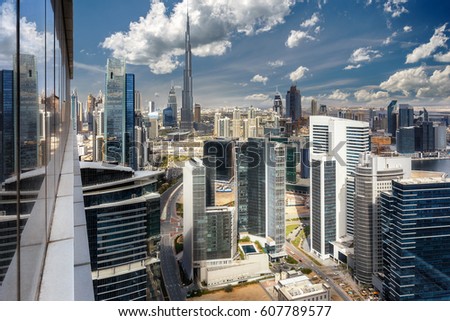Aerial view over skyscrapers of a big modern city. Office buildings of downtown Dubai, United Arab Emirates. Scenic daytime skyline. Travel and architecture background. 