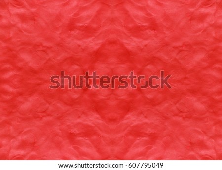 Red background with fingerprints made from plasticine.  Royalty-Free Stock Photo #607795049