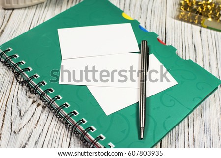 blank sheet of paper, notepad, pen and other supplies on office wooden table. Top view