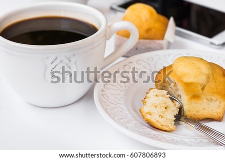 White desktop with cup of coffee, plate with muffin and smartphone, styled image for social media, female blogging, business, website header