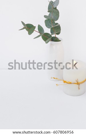 Eucalyptus branch in ceramic vase burning candle on white background, styled image for social media, blogging, product mockup