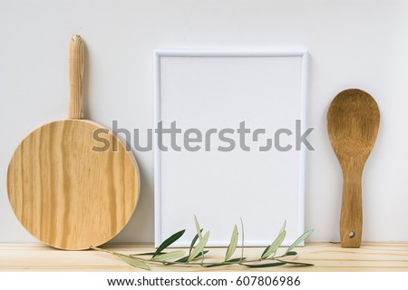 Frame mockup, wood cutting board, spoon, olive tree branch on white background, styled image, product marketing, banner, online store
