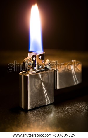 macro metal lighter petrol On black background, open fire