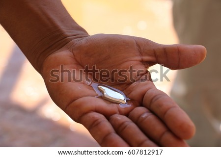 Mercury liquid holding in a hand Royalty-Free Stock Photo #607812917