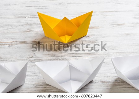 Set of origami boats on wooden table