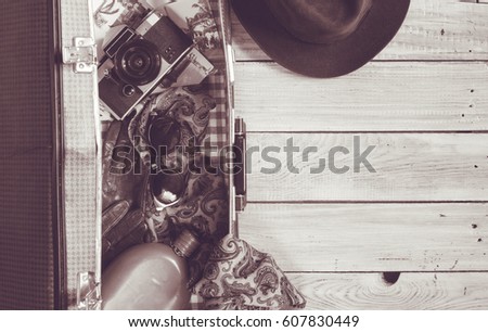 Man's hat and retro accessories for travel on a white painted wooden surface