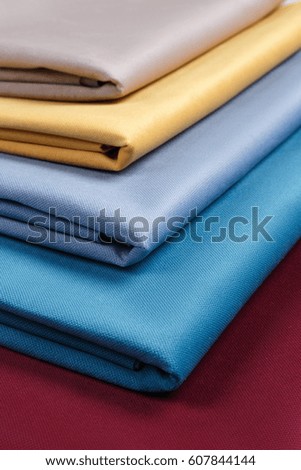 Fabric neatly folded, laid out with different patterns for design