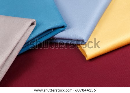 Fabric neatly folded, laid out with different patterns for design