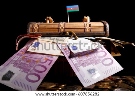 Azerbaijani flag on top of crate full of money