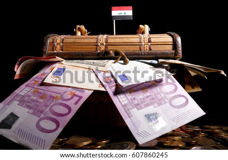 Iraqi flag on top of crate full of money