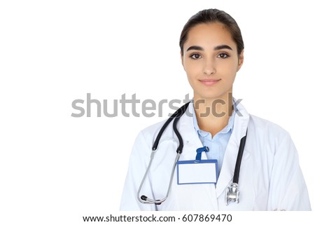 Cheerful smiling female doctor isolated over white background. Latin american or Hispanic young woman