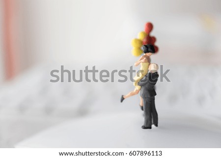 Miniature couple with balloon using as background love couple or valentine's day  concept..