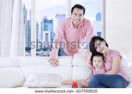 Picture of young family enjoying time on the couch while playing together in the apartment