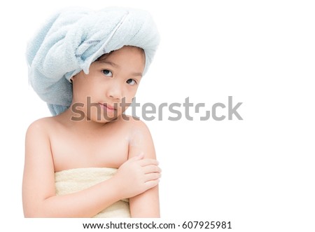 cute girl with a towel on her head applied body cream on her hands isolated on white background