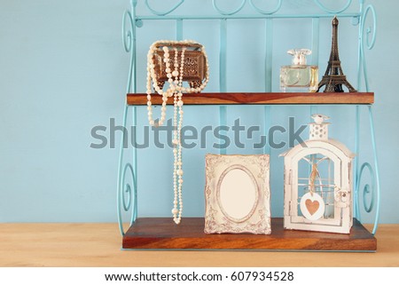 Classic shelf with vintage objects and blank frame. Ready to put photography
