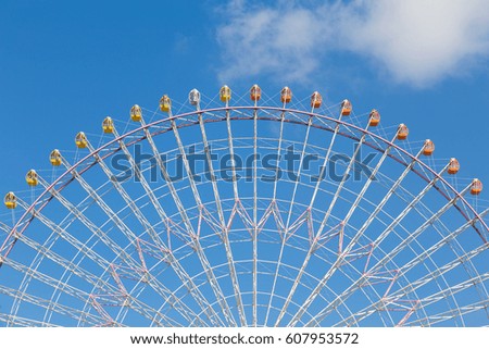 Big funfair festival ferris wheel against blue sky background