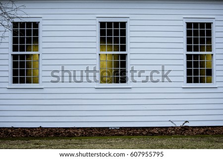 Church Exterior Wall: The white exterior wall of a church. Royalty-Free Stock Photo #607955795