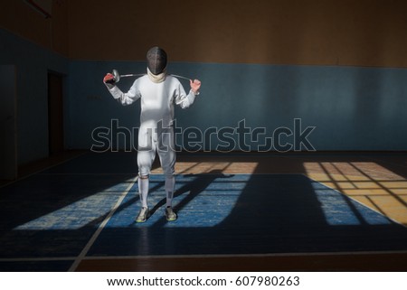 Handsome fencer prepares for competitions and a training. Fencer stand with sword and mask. Fencer with sword. Sword. Men with sword. Fencing. Training. Motivation. Sport. Sport man, Young man