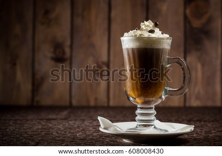Coffee drink with cream on a wooden background
