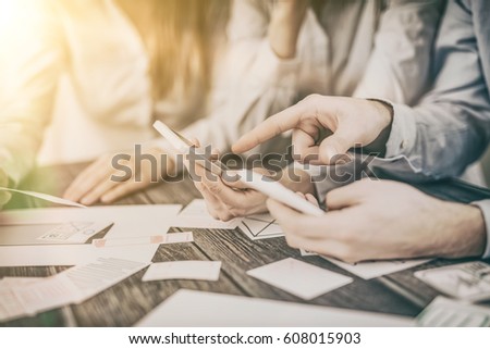 A group of people designers designing a wireframe application of mobile phone and responsive websites. Teamwork and user experience. Royalty-Free Stock Photo #608015903