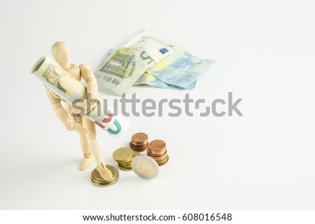 A wooden figure with a bunch of bank notes under his arm, some coins at his feet