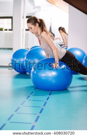 Young woman exercise with pilates balls in the gym