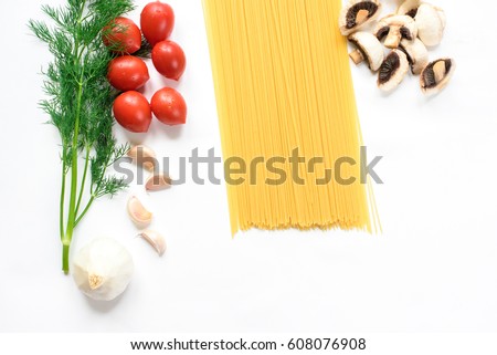 A minimalistic picture of a composition of pasta ingredients isolated in white. Pasta, tomatoes, greens, mushrooms, garlic, top view, copy space. Healthy foods, cooking and vegetarian concept summer.