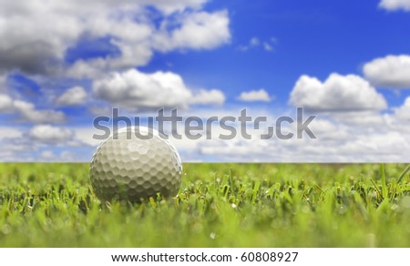 One gold ball on a open golf course - very shallow depth of field