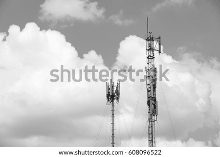 Towers for receiving data on blue sky background - black and white