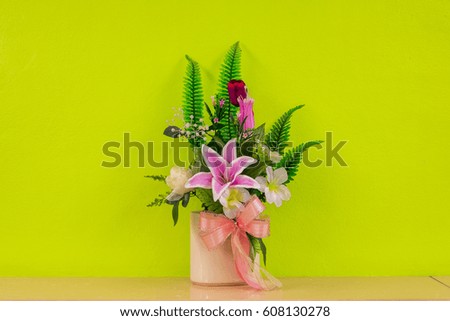 The flower bouquet in the vase on the floor with sweet yellow green background. 