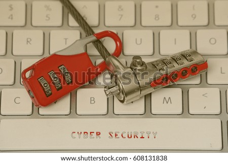 Information and technology security concept. Red padlock with notes written CYBER SECURITY. Vintage editing.                               
