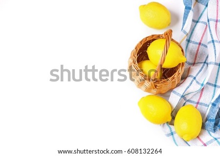 Decorative wicker basket with bright yellow lemons. Ingredient for lemonade. Flat lay food photography. Copy space. Mockup. Image for blogs and web sites