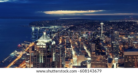 Seattle rooftop panorama view with urban architecture at night.