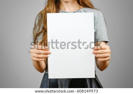 Woman showing blank white big A4 paper. Leaflet presentation. Pamphlet hold hands. Girl show clear offset paper. Sheet template. Booklet design sheet display read first person