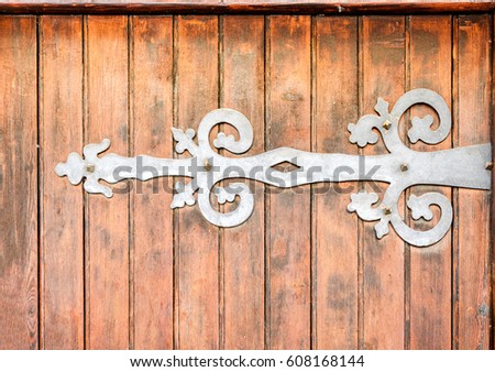 Wrought iron door hinge with spiral shapes