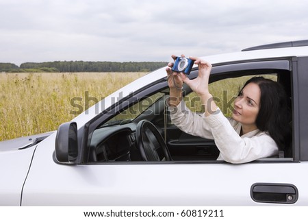Female driver taking picture during her journey