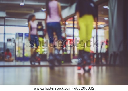 Blurred of an unidentified group of woman  doing exercises fitness with kangoo shoes in glass fitness studio.The best background for use.Cross processing and Split tone new colour trend like process.