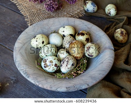 Easter composition. Quail eggs in a wooden plate, Easter. selective focus and toned image
