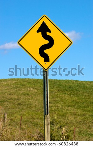 Curvy road sign on a country road