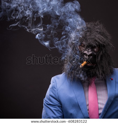 businessman wearing gorilla mask and smoking cigar