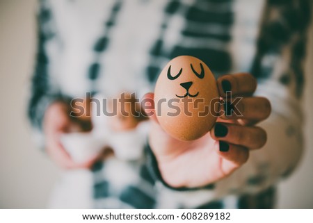 Hands holding modern painted easter eggs. Toned picture